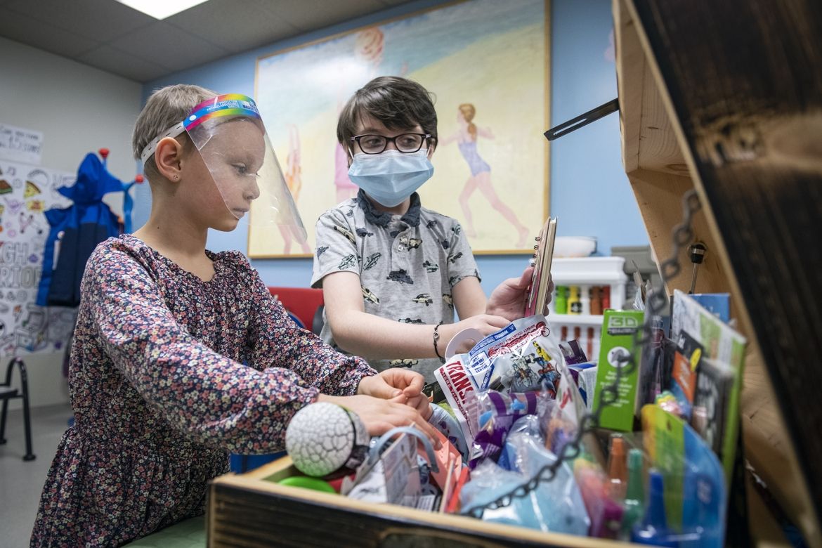 Robbie and a friend exploring all of the treasures inside the treasure chest