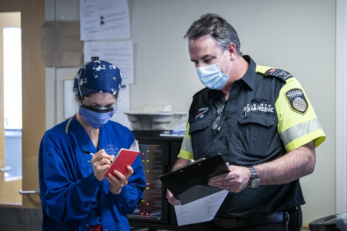 KHSC ICU staff working with Toronto paramedics to transfer patient care