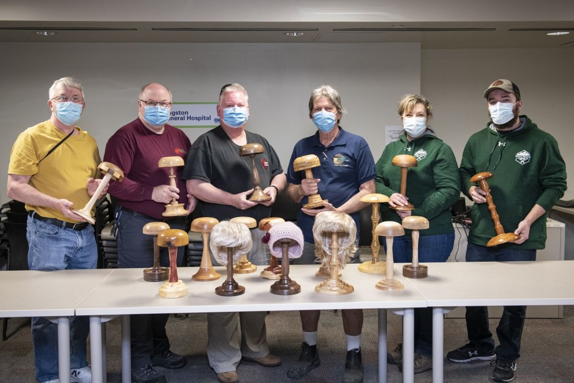 Members of the Kingston Woodturners with the donated wig stands