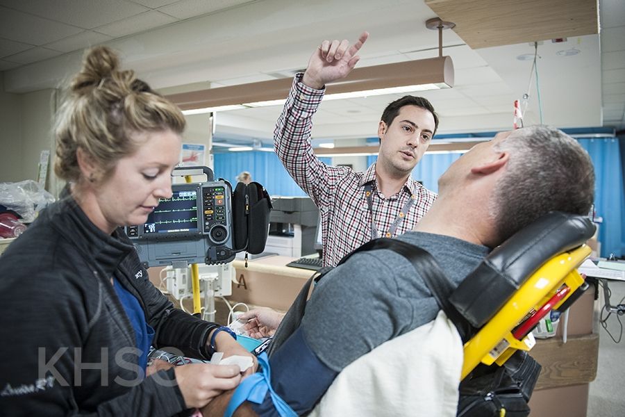 KHSC staff and physicians with with a mock patient in the Emergency Department during an EVT simulation case