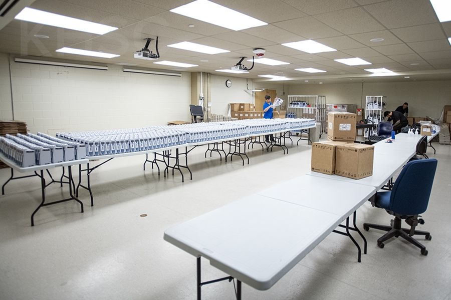 Staff from BD work at the KGH site unloading pallets of new pumps and unpacking each unit before testing and certification for deployment.