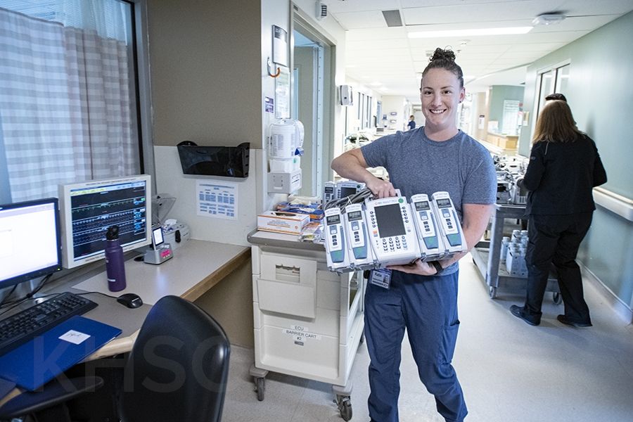 Kadie Weekes, a Critical Care Nurse on Davies 4 ICU receives a new Alairs Infusion controller with pump modules during the implementation phase of the project.