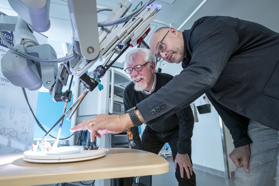 Dr. Robert Siemens and Mr. David Bailey, a patient who received robotics assisted surgery, review the functionality of the newly launched robotic surgical system