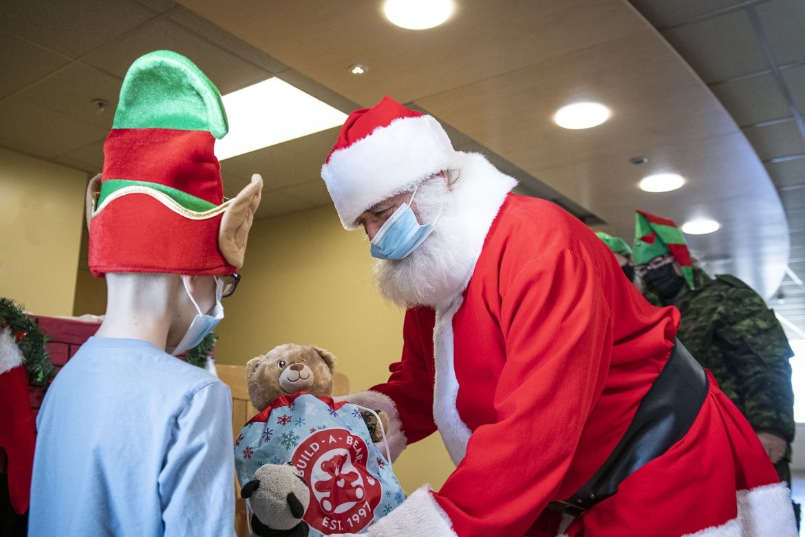Santa distributes toys donated by the Royal Canadian Air Force to pediatric patients at KHSC