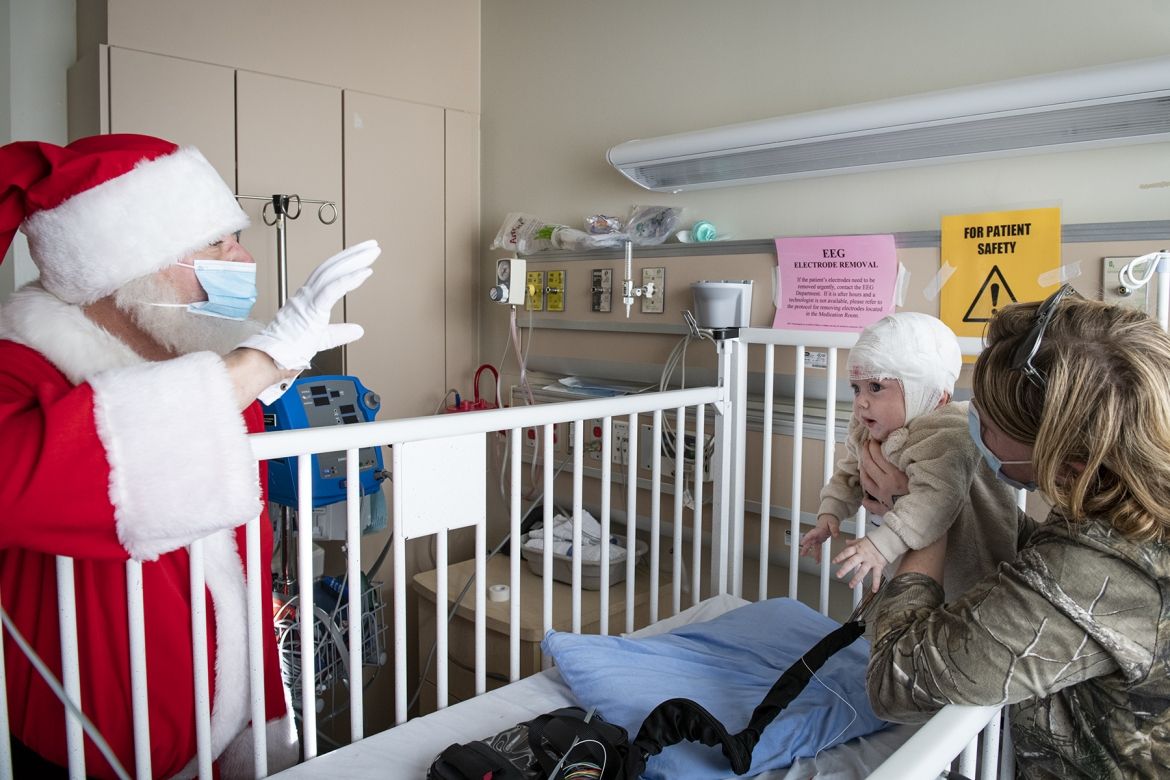 Santa distributes toys donated by the Royal Canadian Air Force to pediatric patients at KHSC