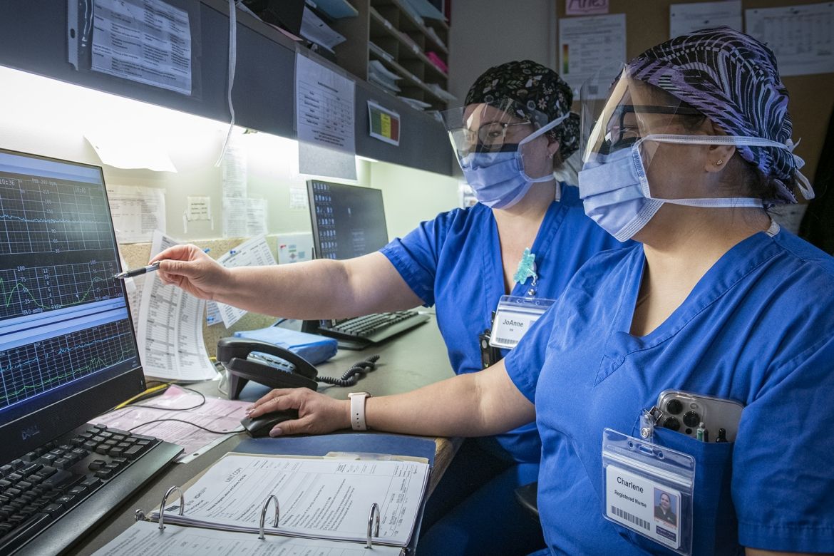 nurses reviewing monitor results