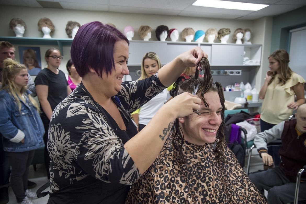 Josh holds the braid that was cut off by Andrew