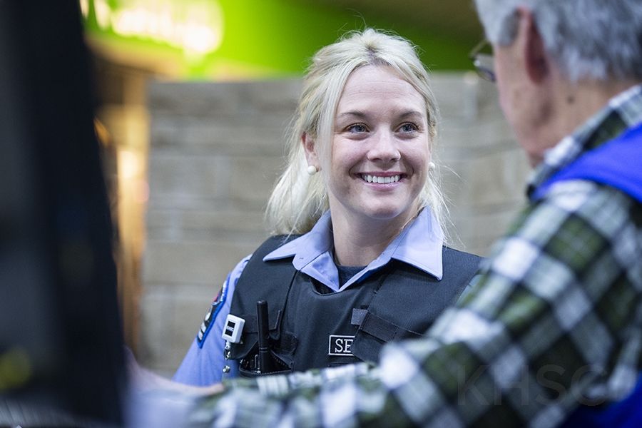 Security Guard Brittani Roberts meets with volunteers at the information desk in the main lobby of our KGH site