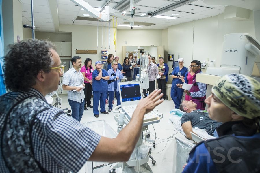 KHSC staff and physicians in an Interventional Radiology suite during an EVT simulation case
