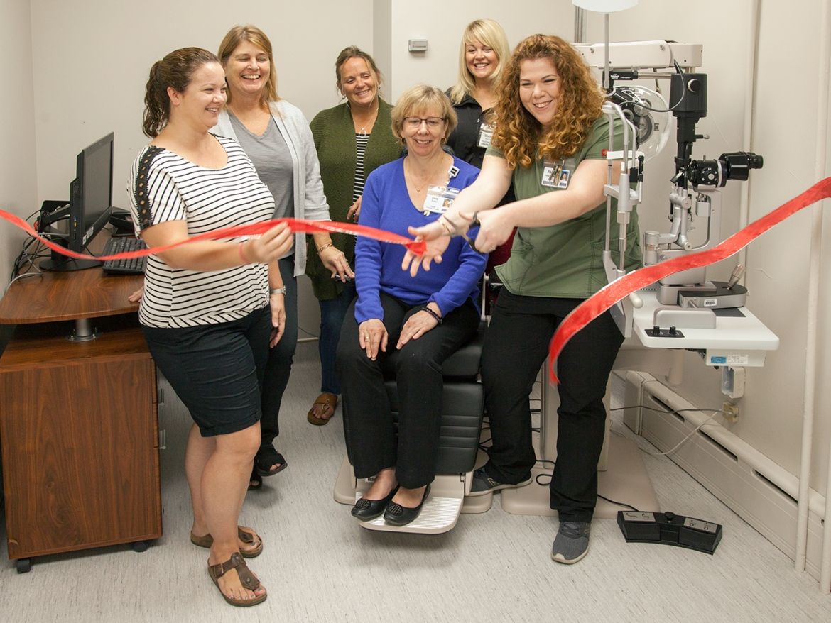 red ribbon cutting for renovated clinic