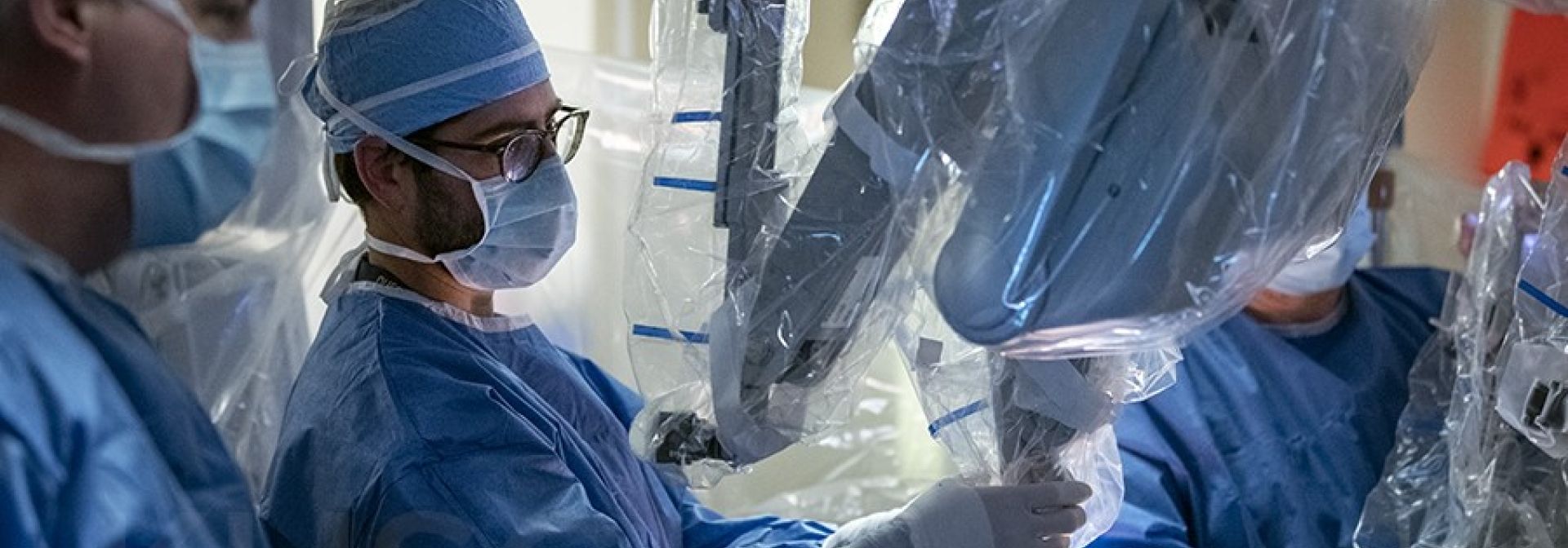 A group of physicians inspecting surgical equipment.