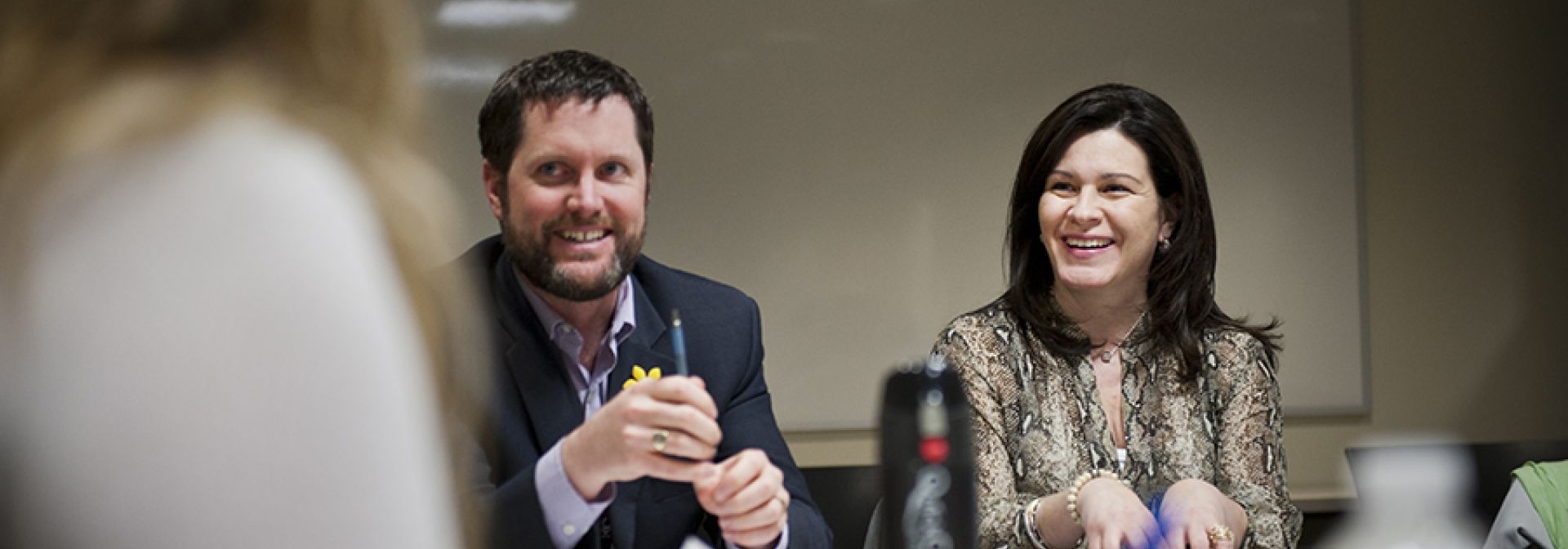 Patient Experience Advisors sitting at the table with staff.