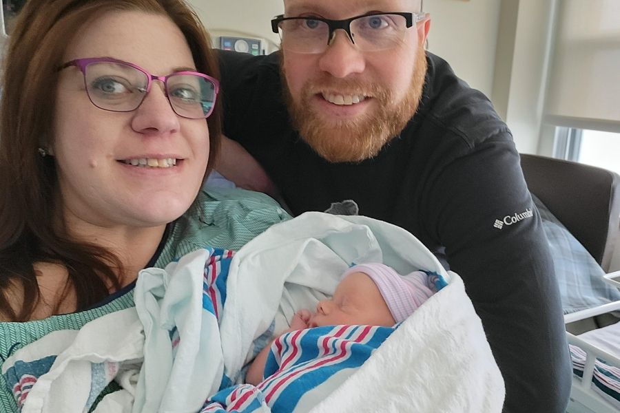 young couple holding newborn baby