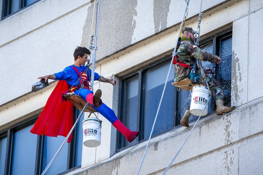 People of KHSC: Dennis Clark Dennis Clark is pictured hanging off the side of the KGH building with window washing equipment, dressed as Superman.