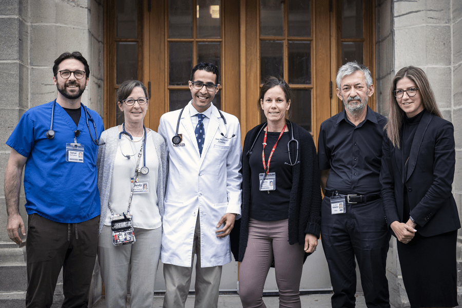 Members of the Heart Function Clinic team stand together outside the Hotel Dieu Hospital site.