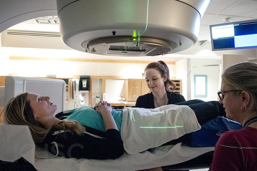 Cancer centre staff operating equipment