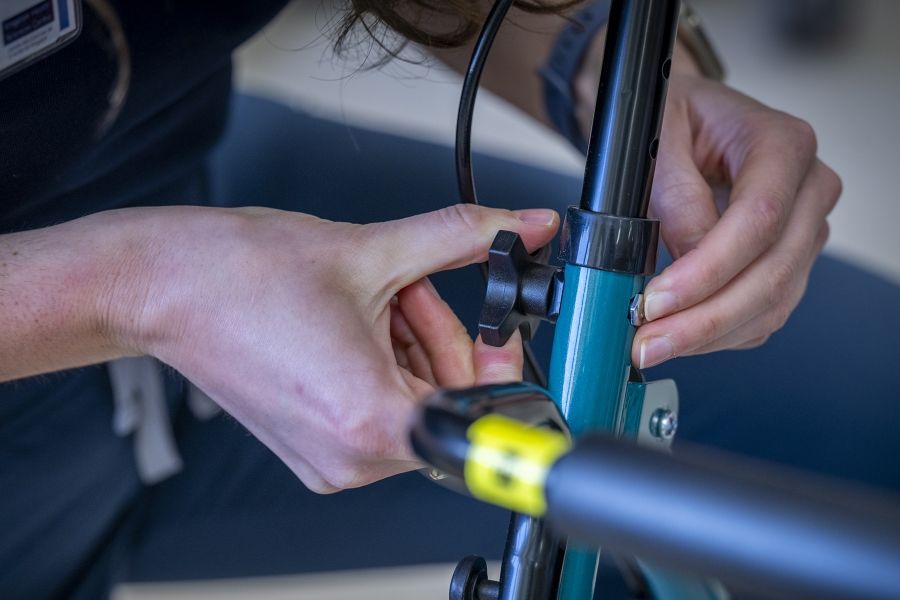 PeopleOfKHSC_Justine_White_8 A close up shot of Justine White’s hands working on a walker, a mobility aid device. She’s tightening a screw.