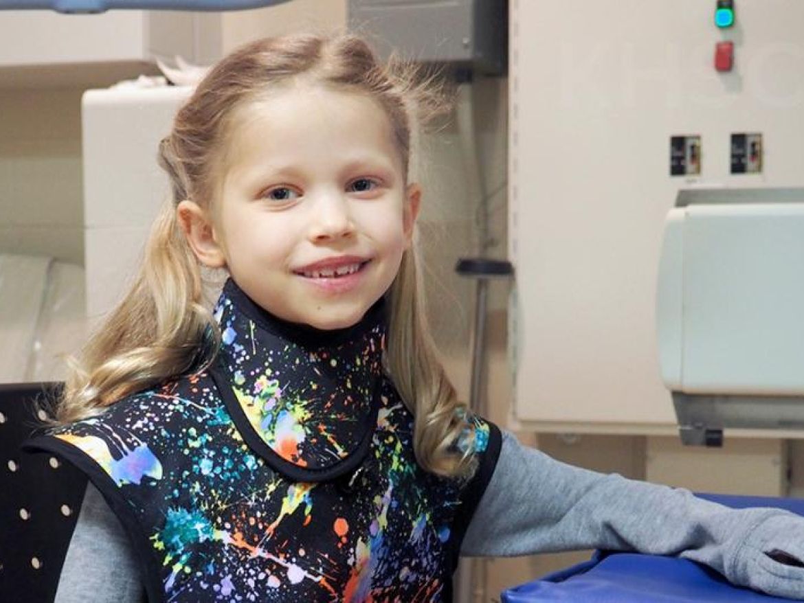 Ella models the new pediatric apron that was inspired by her experience in the Diagnostic Imaging department