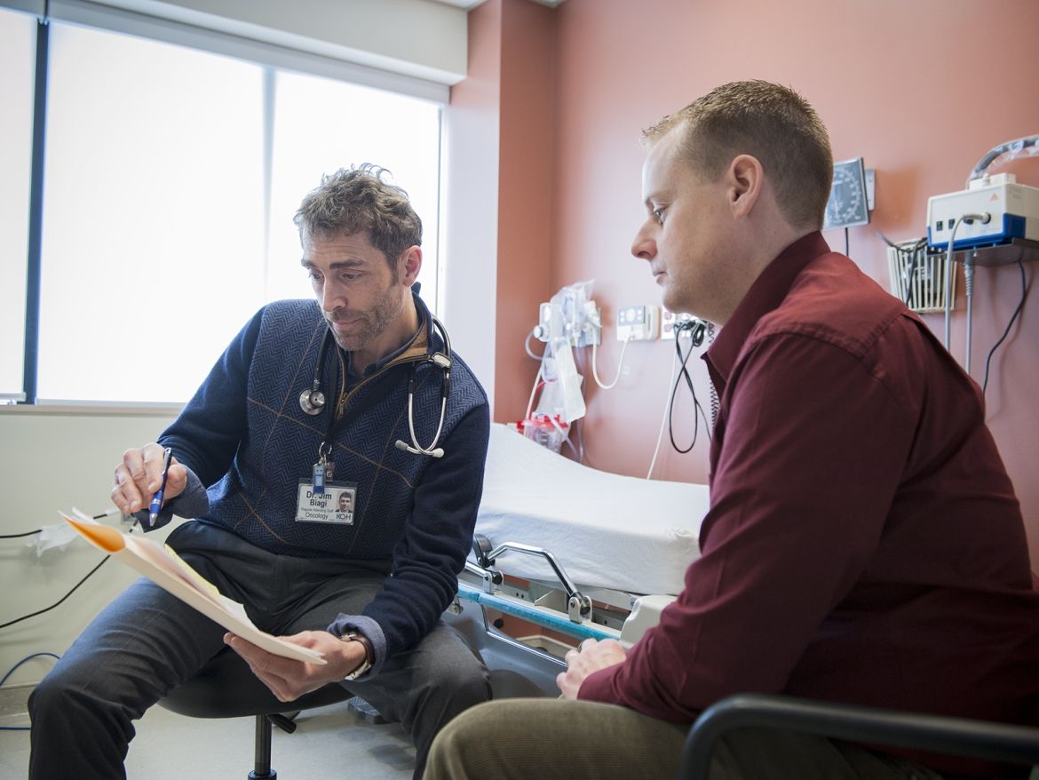 A doctor speaks with a patient about their medication history