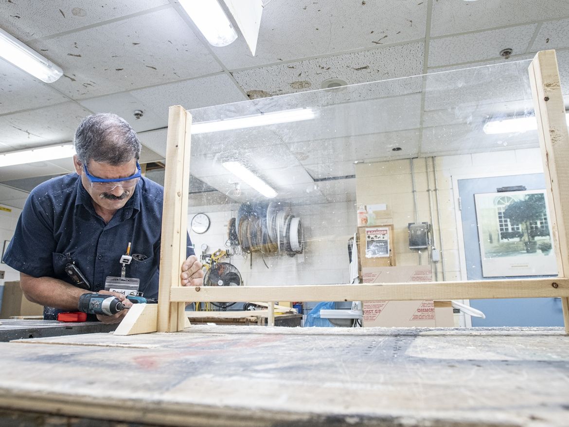 Carpenter David De Sousa working on screening stations.