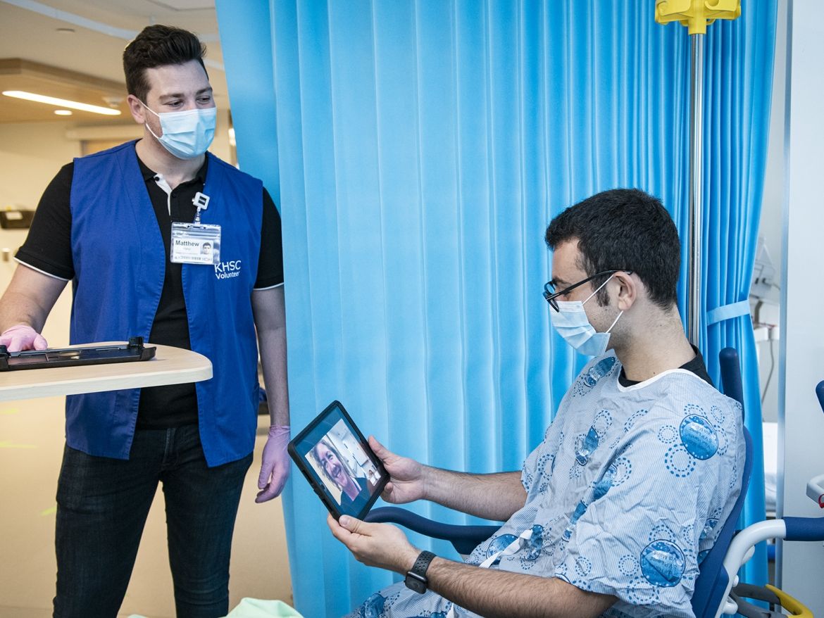 Volunteers helping patients have virtual visits.