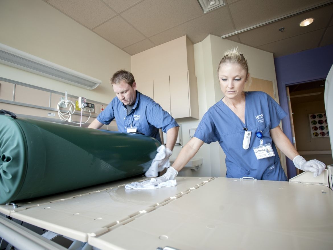 Staff cleaning a patient room