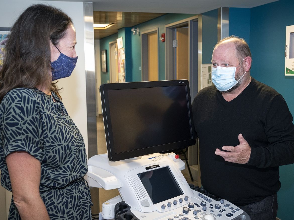 Mike McDonald talking with staff at Street Health Kingston.