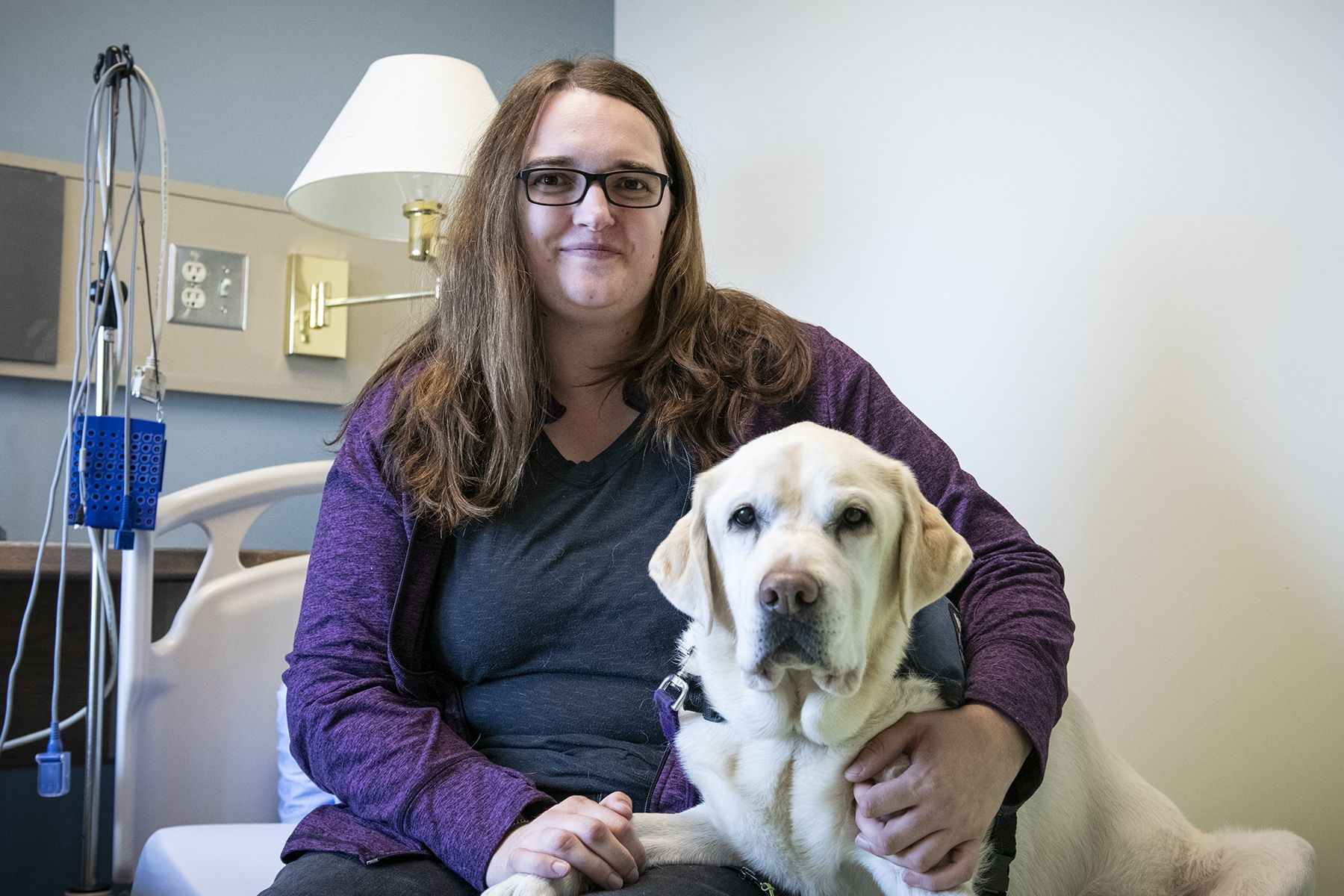 Joanna Hearn at KHSC's Sleep Lab with her now-retired service dog Lucy, a yellow Labrador. Joanna Hearn and her dog