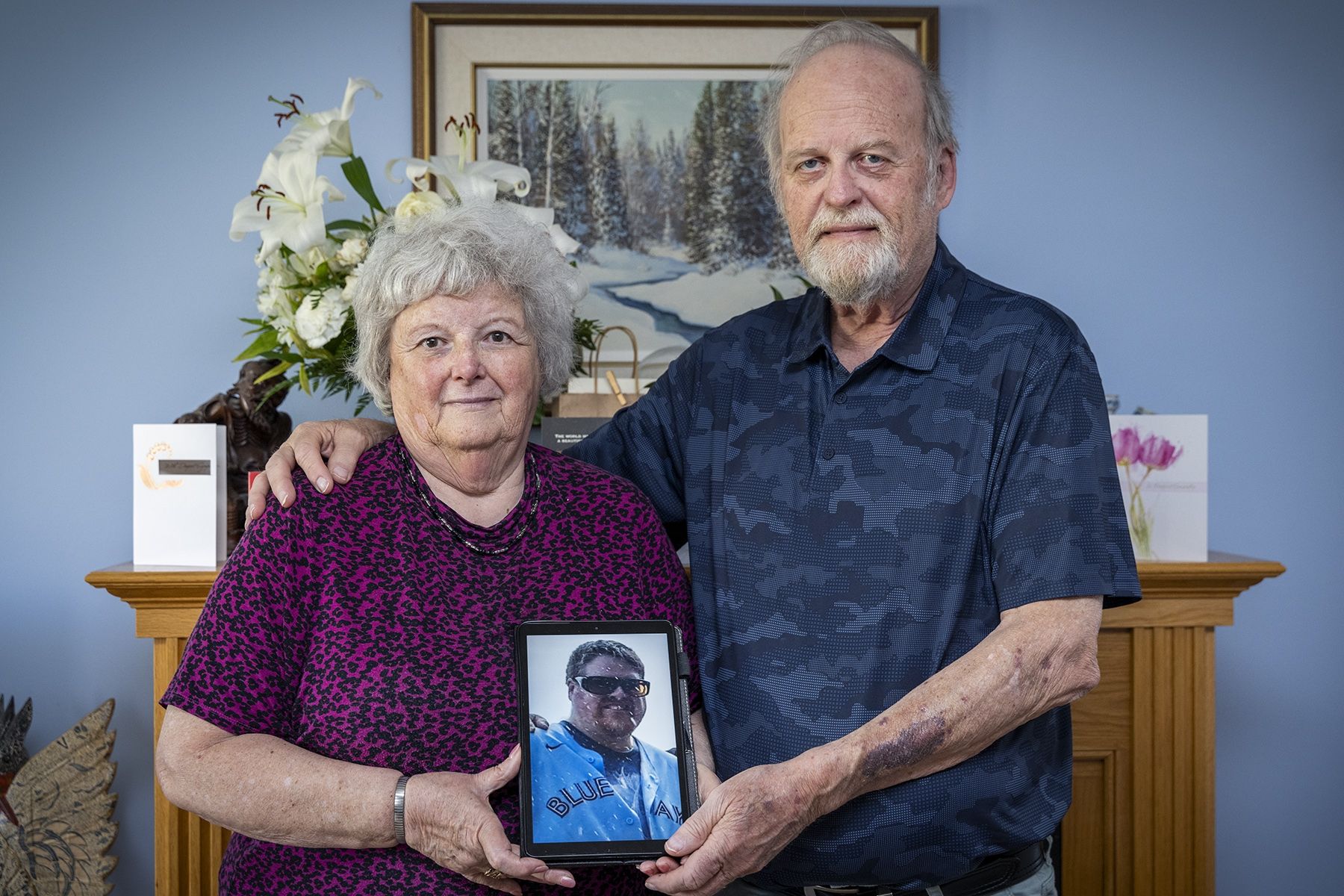 Robert Louis “Robbie” Sherren's parents stand holding a photo of him. Robert Louis “Robbie” Sherrens parents stand holding a photo of him.