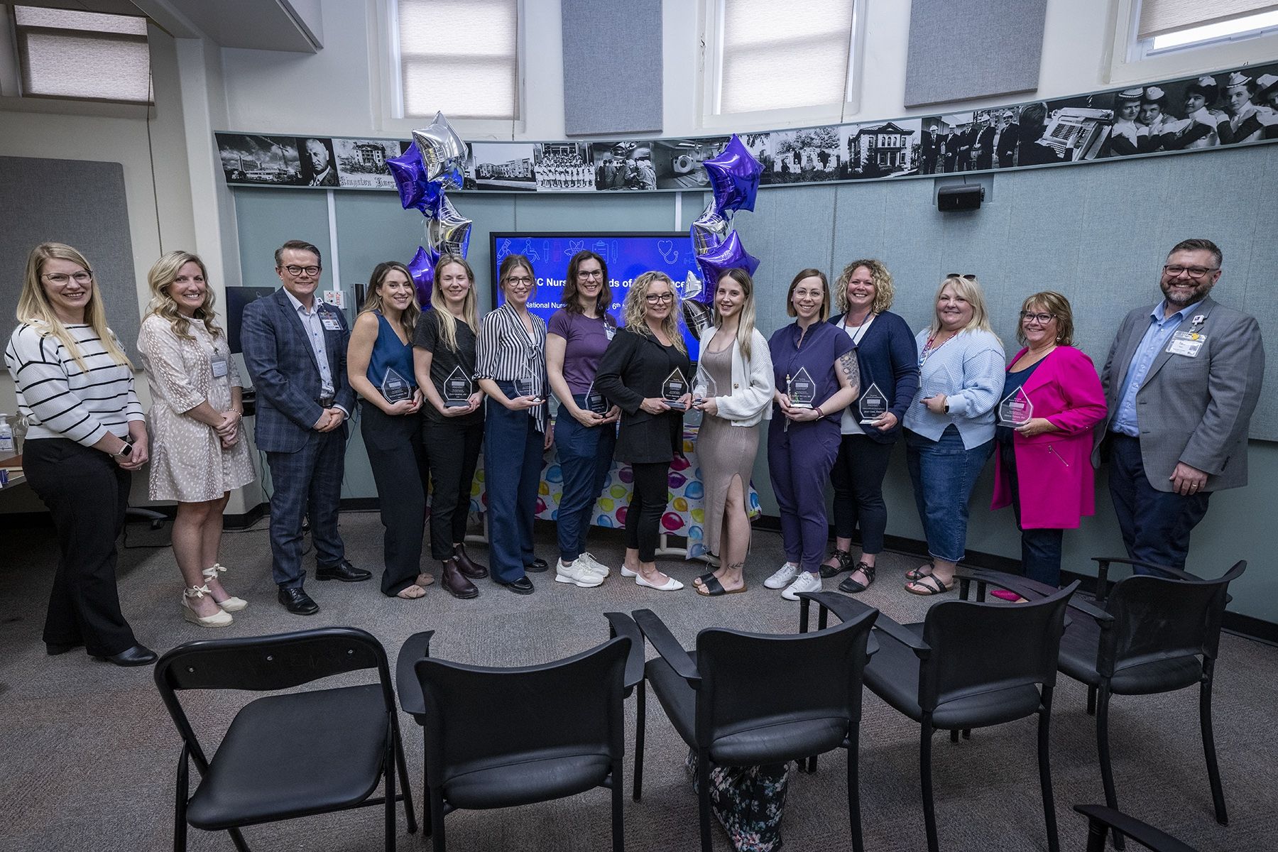 A group of nurses holding awards to celebrate their excellence 