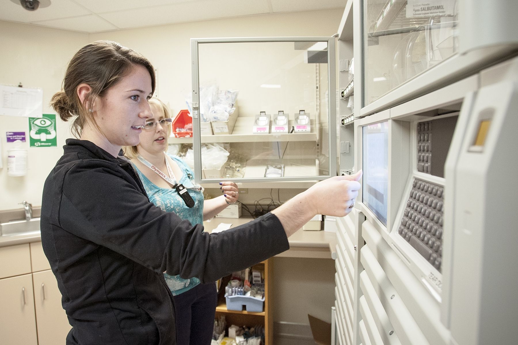 Kathleen McKee, Registered Nurse, (front) gets some hands-on training on how to use a cabinet from Melanie Foisy, Clinical Educator, on the Davies 4 Intensive Care Unit at Kingston General Hospital.