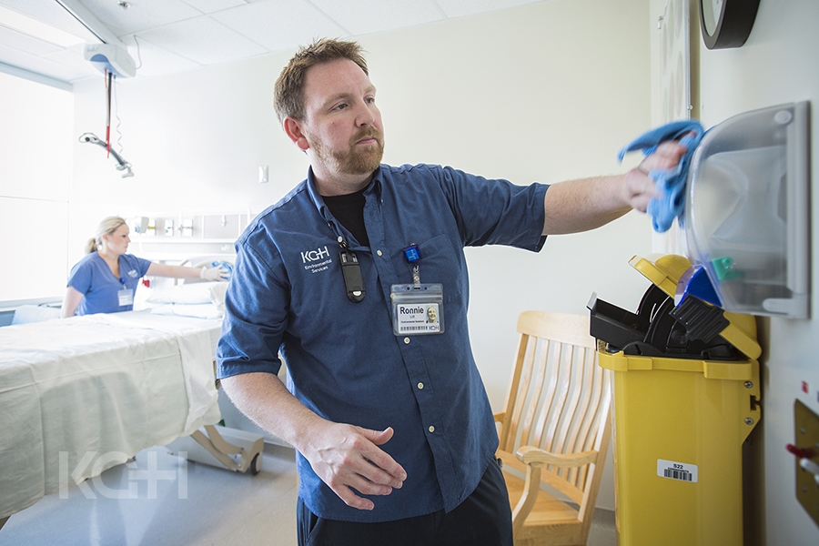 Environmental Assistants Ronnie Lott and Melissa Sauve clean all of the surfaces in a patient care room on Kidd 10. 