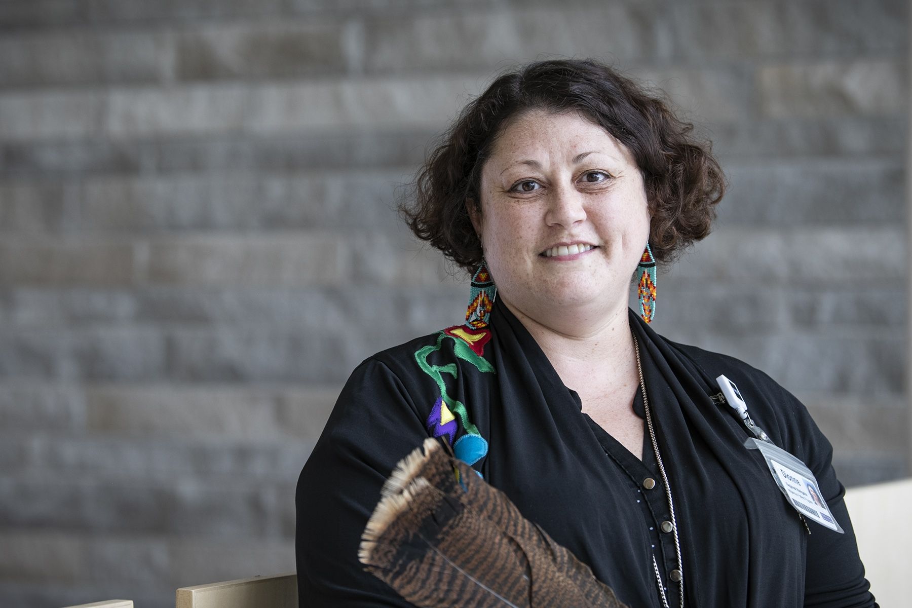 Dionne Nolan has short, brown, wavy hair. She's photographed standing outside the Kingston General Hospital site.